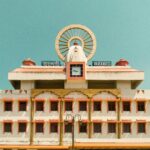 Architectural facade of Varanasi Junction with clear blue sky.